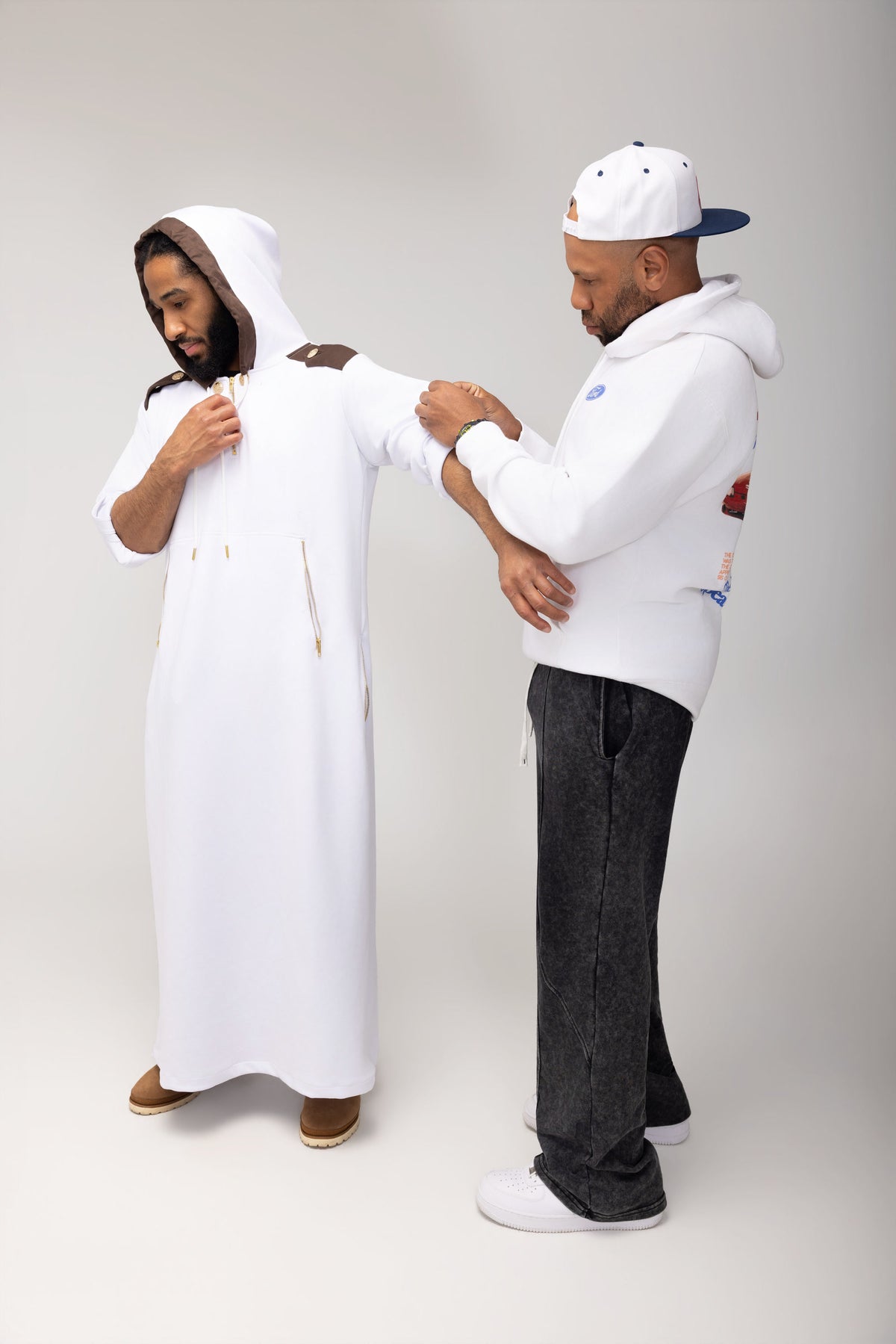 COMOS ethos hero - two men fitting hooded thobe